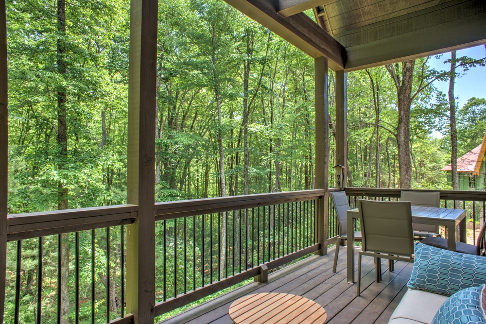 Covered Deck with Seating and Wooded Surroundings