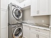 Stack Washer & Dryer Located in the Laundry Area