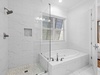 1st Floor Primary En Suite - Featuring a Glass-enclosed Shower and Separate Soaking Tub