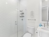 Single Queen Bathroom — Walk‑in shower and single vanity.
