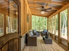 Soak up the beauty of nature in the screened in back porch.