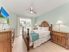 Wake up refreshed in this coastal-inspired bedroom with fresh linens, tropical wood furnishings, and your own private balcony access for morning coffee or evening breezes.