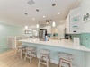 Gather around this bright coastal kitchen where ocean-inspired tiles and beachy décor set a relaxed tone for your morning coffee or easy meal prep together.