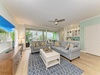 Sink into plush seating and watch your favorite shows on the large TV, with soft coastal breezes drifting through as you unwind in this bright, open living space.