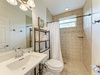 Step into your private bathroom with elegant tile work, spacious walk-in shower, and plush towels ready for you after a refreshing rinse.