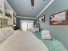 Relax in your coastal-inspired retreat with a plush bed dressed in crisp linens, soothing teal accents, and artwork that brings the desert and palms to life around you.