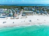 Stunning beachfront community showcases pristine white sand, crystal-clear turquoise waters, and charming coastal homes with convenient beach access.