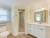 Refresh in your private spa-like bathroom featuring a walk-in shower, elegant vanity, and coastal charm.
