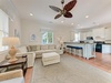 Unwind in this airy open-concept living space with plush seating, a coastal vibe, and a fully-equipped kitchen for preparing your favorite meals.