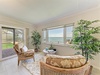 Unwind in this serene coastal retreat where wicker seating and lush greenery frame stunning ocean views, inviting you to relax and soak in the tranquil seaside ambiance.
