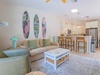 Unwind on plush seating as coastal vibes greet you, then gather at the kitchen island over shared meals and laughter in your bright, beach-inspired retreat.