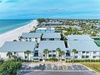 Beachfront property complex featuring multiple residential units with direct beach access and oceanfront views in a tropical coastal setting.