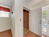 The property features a gated entrance with tiled flooring, providing secure access and a glimpse of the pool area just beyond.