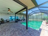 Step into your private oasis where a screened pool beckons under soaring ceilings. Lounge on the covered patio, breathe in the Florida sunshine, and let vacation mode begin.