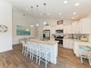 Your bright, beachy kitchen awaits with a spacious island for gathering, modern appliances, and coastal charm that makes meal prep feel like a vacation ritual.