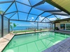 Your private screened pool with stunning waterfront views—dive in and feel the Florida sun warm your skin while gazing at the endless blue horizon.