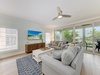 Sink into plush seating as the ceiling fan gently stirs the breeze. Your private screened balcony frames lush tropical views—perfect for morning coffee or evening unwinding.