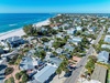 Stunning beachfront community with pristine white sand beach and turquoise waters just steps from charming coastal homes.
