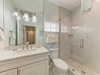 Refresh in your private spa-inspired bathroom with a spacious walk-in shower, marble countertops, and soothing coastal tones that invite relaxation after a day of adventure.