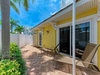 Your private patio offers a peaceful retreat with sunny loungers and lush tropical greenery, perfect for morning coffee or evening relaxation in the warm Florida breeze.