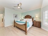 Drift off in this coastal-inspired bedroom where soft aqua walls and natural light create your peaceful escape. Crisp linens and elegant wood furnishings welcome you to unwind.
