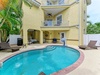 Private pool surrounded by tropical palms and spacious lounging areas where you can soak up the sun or relax under shaded balconies.