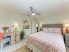 Relax in your coastal-inspired bedroom, complete with a plush bed, soothing décor, and a ceiling fan to keep you comfortable year-round.