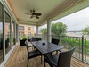 Relax on your private screened balcony with dining and lounge seating overlooking lush greenery. The ceiling fan keeps you comfortable while you enjoy peaceful treetop views.