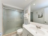Step into your private bathroom featuring a spacious walk-in shower and bright, clean finishes for your comfort.