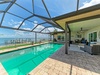 Your private pool awaits under a screened enclosure, with stunning waterfront views and a spacious patio for lounging in comfort and style.