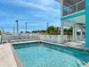 A sparkling pool awaits, framed by swaying palms and Florida sunshine. Unwind on the lounge chairs with tropical breezes and bright blue skies overhead—your perfect escape.