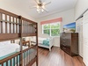 Your cozy room features a sturdy bunk bed and a comfortable twin bed, perfect for family or friends. Natural light fills the space, and a ceiling fan keeps you cool after beach adventures.