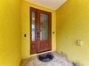 A welcoming entrance with cheerful yellow walls and elegant stained glass doors, where your vacation begins the moment you arrive.
