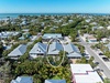 Aerial view of coastal neighborhood with property highlighted near beach community and amenities.