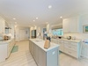Your fully equipped kitchen features granite counters, stainless appliances, and a center island—perfect for cooking together or savoring morning coffee as light fills the space.