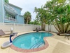 Dive into your private tropical oasis with a sparkling pool surrounded by lush palms, shaded loungers, and your own mini basketball court for fun in the sun.