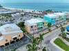 Beachfront property in a tropical coastal community, steps from turquoise waters and white sand beaches with convenient parking nearby.