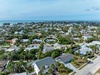Aerial view showcasing the beachside neighborhood location with ocean access and tropical residential surroundings.