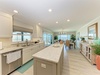 Step into a beautifully renovated kitchen where coastal light pours through ocean-view windows. Crisp white cabinetry, granite counters, and stainless appliances invite you to cook and gather with stunning sea vistas as your backdrop.