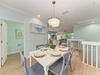 Gather around this stylish dining table for six, where coastal charm meets modern comfort beneath an elegant chandelier in your bright, open-plan living space.