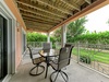 Your private covered terrace invites you to unwind with morning coffee or evening meals, overlooking lush gardens and greenery that create a peaceful, secluded retreat.