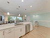 Your fully equipped kitchen flows into a bright living area with balcony access, perfect for preparing meals while enjoying tropical views and coastal breezes.