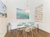 Gather around this coastal-inspired dining space, where ocean-themed artwork and shell decor set the stage for memorable meals with your loved ones.