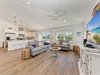 Unwind in your bright open living space where coastal vibes meet comfort. Natural light floods through large windows, plush sofas invite relaxation, and your fully equipped kitchen awaits your favorite meals.