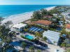 Beachfront resort property with swimming pool and direct beach access on pristine coastline.