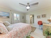 Drift off in this serene coastal bedroom where soft coral tones and beachy decor create your perfect retreat. Natural light and ceiling fan keep you comfortable year-round.