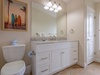 Step into your bright, coastal-inspired bathroom featuring a spacious vanity, soft natural light, and beach-themed touches that bring a relaxed vacation vibe to your daily routine.