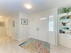 A bright, welcoming entryway greets you with elegant coastal décor, decorative glass accents, and thoughtful touches that set the tone for your beach getaway. Your home away from home starts here.