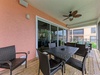 Enjoy your morning coffee or evening breeze on your private screened balcony, complete with a ceiling fan and comfortable outdoor dining for six. The space flows seamlessly into your living area, perfect for relaxed indoor-outdoor living.