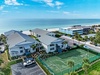 Beachfront property featuring tennis court, parking, and prime location steps from pristine white sand beach.